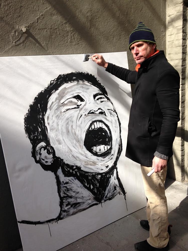 Christopher Flach at work on a large-scale black-and-white portrait painting