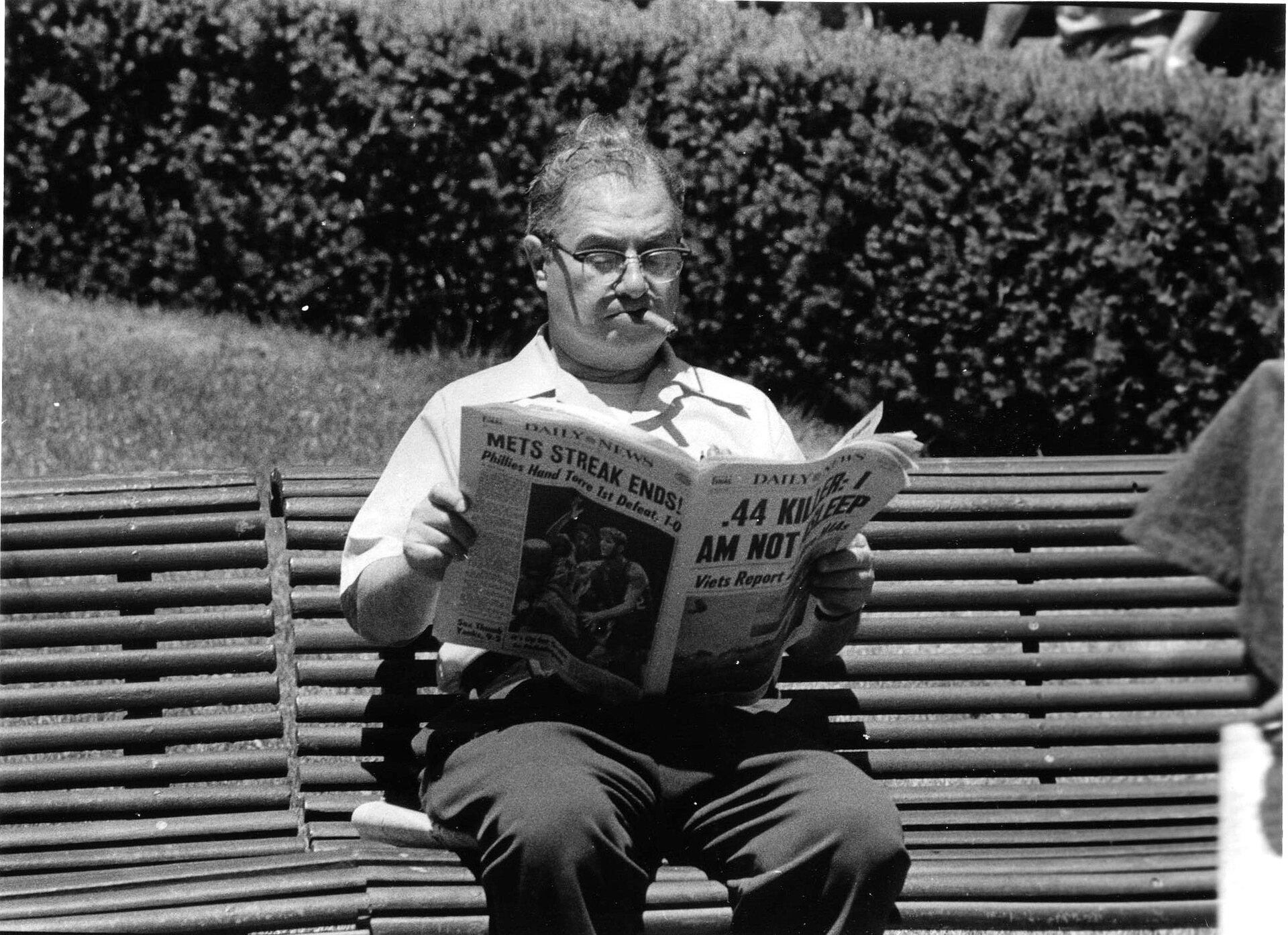Central park 1970s man reads newspaper, by Christopher Flach