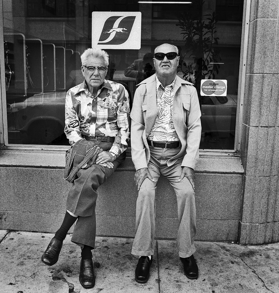Men at bus station, by Christopher Flach
