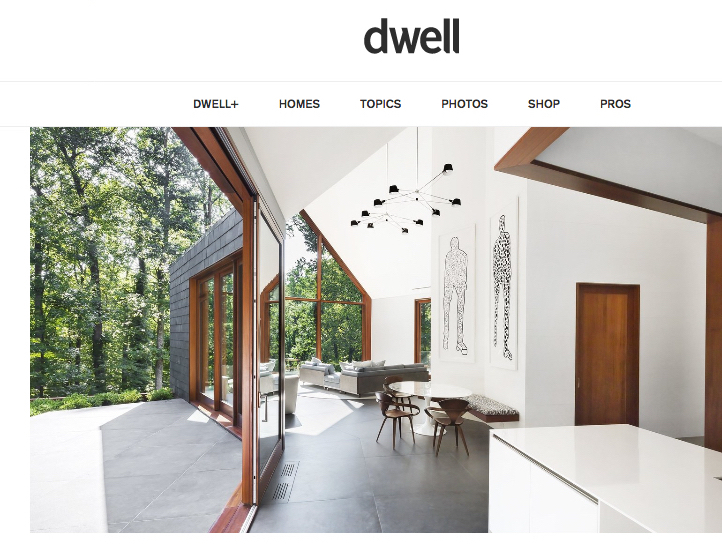 Two tall Christopher Flach figure drawings in a modern house featured in Dwell